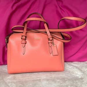 Salmon colored Coach crossbody purse and matching wallet